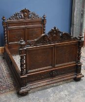 A Victorian carved oak double bed, with scrolling decoration, height 155cm, width 146cm.