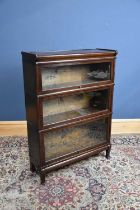 GLOBE WERNICKE; a metal bound oak three tier stacking bookcase with up and over glazed doors,