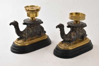Two modern bronzed and brass candle holders modelled as camels, length 25cm.