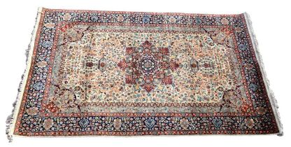 An Indian designed floral decorated rug with allover design on a cream, rust and blue ground, 212