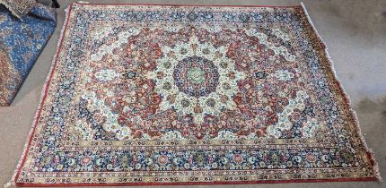 A red ground Shiraz carpet, with central geometric decoration, 250 x 340cm.