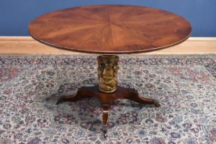 A reproduction walnut and rosewood tilt-top table with gilt column relief decorated with busts,