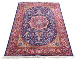 A Sarook Kashan machine woven part silk carpet, worked with a central medallion against an oval blue