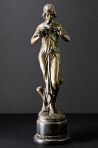 A reproduction bronze figure of an Art Nouveau style maiden with a band to her hair and a floral