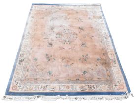 A Chinese wool carpet, worked with an floral design against a pale ground, 376 x 277cm, with a