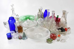 A large quantity of decorative and cut glass including decanters, jugs, bowls, cups, paperweights,