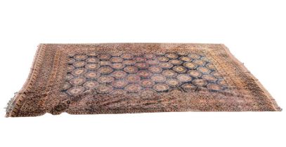 An Eastern style rust ground carpet, with elephant foot decoration to the centre, length 387cm,