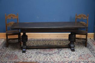A reproduction dark oak refectory dining table on carved pineapple supports, length 210cm, depth