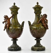 A pair of late 19th century style bronze lidded vases, moulded with cherubs on marble plinth