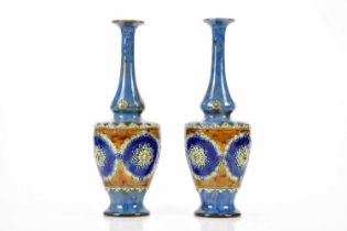 ROYAL DOULTON; a pair of Artware vases of cylindrical form with flared necks, relief decorated