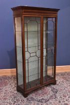 An Edwardian style inlaid mahogany display cabinet, with moulded cornice above astragal glazed