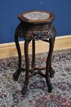 A late 19th/early 20th century Chinese carved rosewood jardinière stand with marble top, height