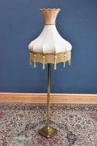 A modern brass Corinthian column standard lamp on paw feet, height including fitting 134cm.