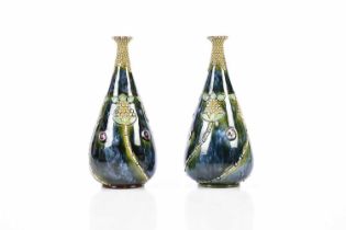 ROYAL DOULTON; a pair of Artware vases of tapering cylindrical form, relief decorated with Art