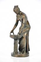 An early 20th century bronzed metal figure of a girl holding a basket, height 25cm.