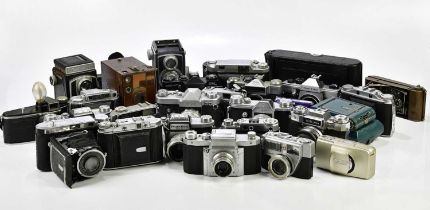 A collection of cameras, mostly 35mm film cameras, to include a Zenit EM, an Olympus mju Zoom 105, a