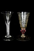 A 19th century wine glass with etched decoration and a cranberry glass air twist stem and a