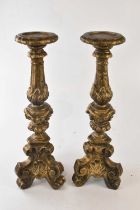 A pair of decorative gilt candle holders in a rococo style, height 56cm (2).