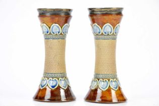 ROYAL DOULTON; a pair of waisted Artware vases, with relief Art Nouveau decoration, with