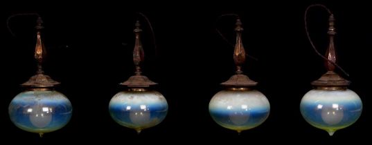 A set of four Arts and Crafts pendant lights with blown bulbous vaseline glass shades, height