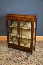 An Edwardian inlaid mahogany display cabinet, the two astragal glazed doors enclosing shelves, width