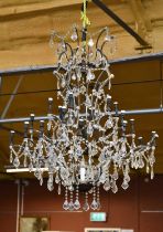 A French style chandelier of large proportions, hung with twenty-three lights and cut glass lustre