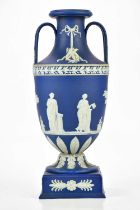 WEDGWOOD; an early 20th century twin handled pedestal urn vase, relief decorated with classical