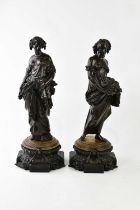 A pair of reproduction bronzed spelter figures representing maidens carrying corn and fruit, on
