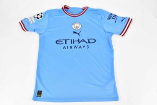 ERLING HAALAND; an autographed replica Manchester City UEFA CHAMPIONS LEAGUE 2022/2023 jersey,