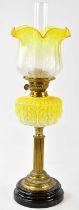 A Victorian oil lamp, the vaseline and clear glass shade with etched floral decoration and wavy rim,
