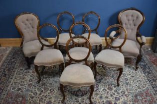 A set of six Victorian balloon back chairs, together with lady's chair and gentleman's chair, with
