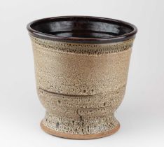 † ABDO NAGI (1941-2001); a deep stoneware planter covered in heavily mottled oatmeal glaze, height