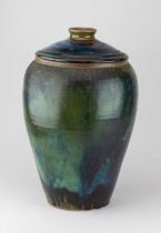 † ABDO NAGI (1941-2001); a tall stoneware jar and cover partially covered in mottled green and