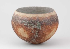 † BETTY BLANDINO (1927-2011); a stoneware bowl with textured surface covered in mottled iron and