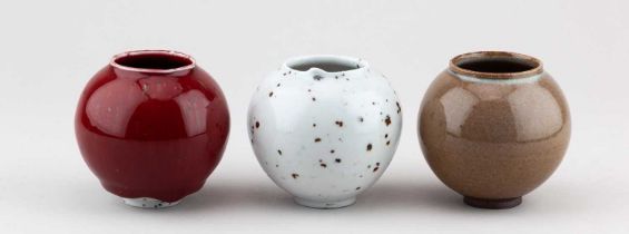 † ADAM BUICK (born 1978); a trio of mini porcelain moon jars covered in different glazes,