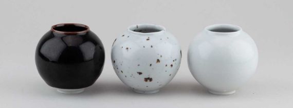 † ADAM BUICK (born 1978); a trio of mini porcelain moon jars covered in different glazes,