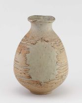 † BARBARA CASS (1921-1992); a faceted stoneware bottle partially covered in oatmeal glaze, incised