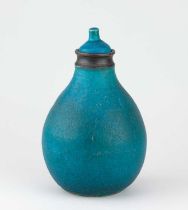 † ABDO NAGI (1941-2001); a stoneware decanter covered in turquoise glaze with bronze rim,