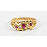 An 18ct yellow gold ruby and diamond five stone ring, size M, approx 3.1g.