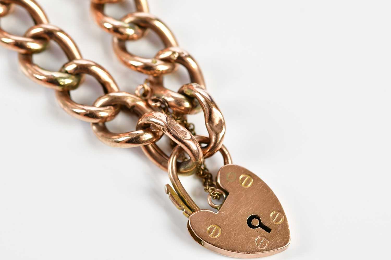 A 9ct rose gold hollow curb link bracelet with padlock and safety chain, approx. 15.85g. - Image 3 of 5