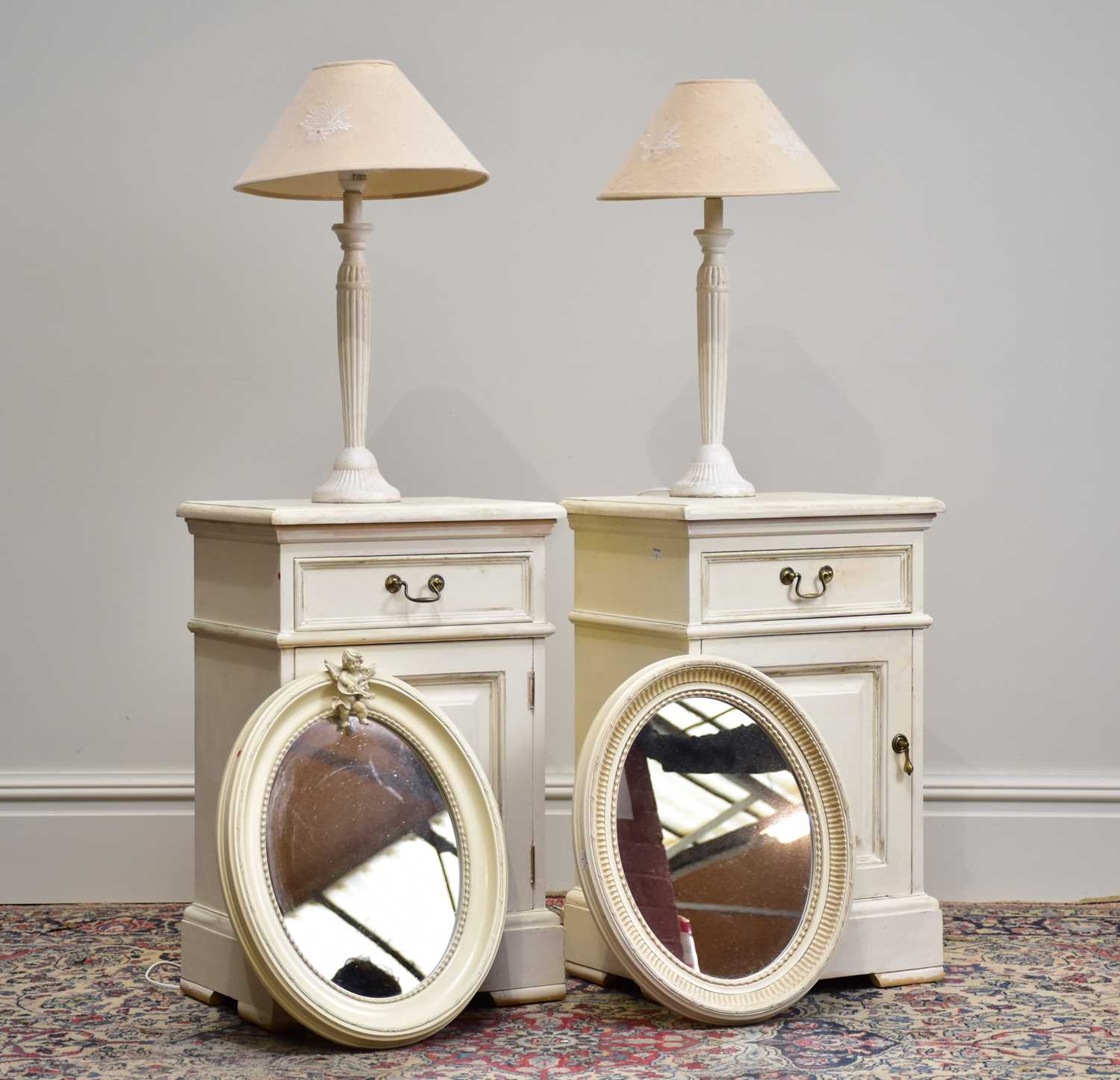 Two modern white painted bedside cabinets with single drawers above two panelled cupboard doors, two