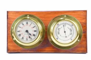 CAPTAIN O M WATTS; a brass cased ship's clock set with Roman and Arabic numerals, with thermometer