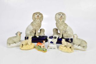 STAFFORDSHIRE; eight 19th century and later figures, including a pair of flatback poodles with pups,