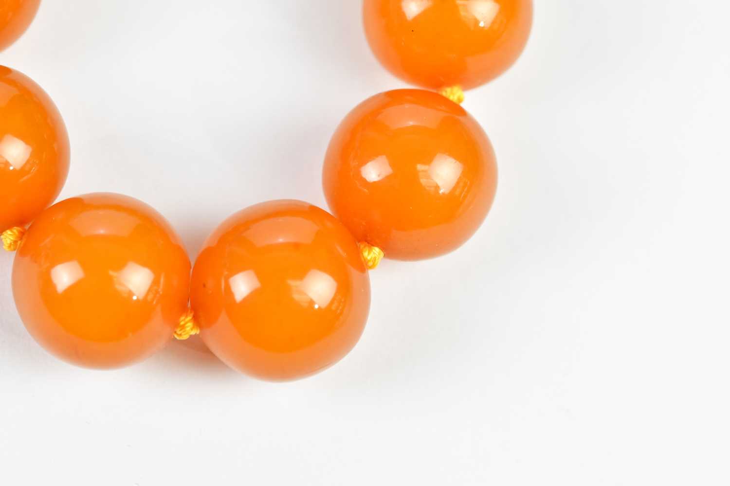 A cherry amber coloured beaded necklace, with silvered bead clasp, approximate weight 67g. - Image 3 of 4