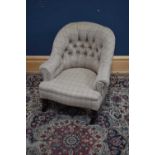 A late Victorian nursing chair, upholstered in a contemporary material.