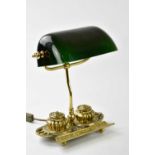 A reproduction gilt metal desk lamp with rotating green glass shade, the base section with