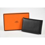 HERMÈS; an unused Calvi Epsom leather black card holder, in original box with receipt, 10.5 x 7cm.