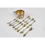 A set of twelve Continental plated tea spoons, with cast foliate detailing, and a white metal mug (