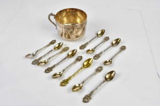 A set of twelve Continental plated tea spoons, with cast foliate detailing, and a white metal mug (