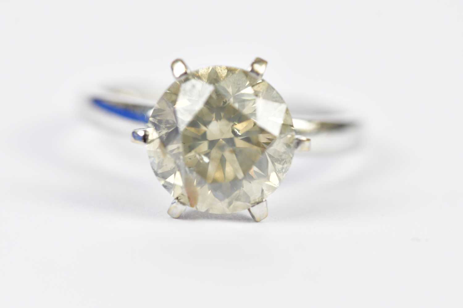 An 18ct white gold diamond solitaire ring, the six claw set round brilliant cut stone weighing 4.
